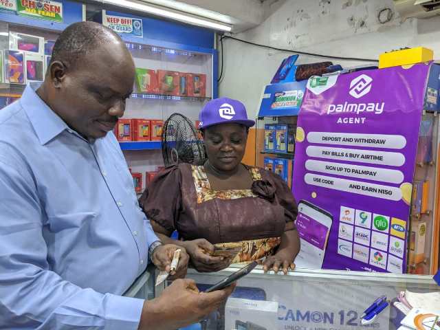 A man at a PalmPay agent booth