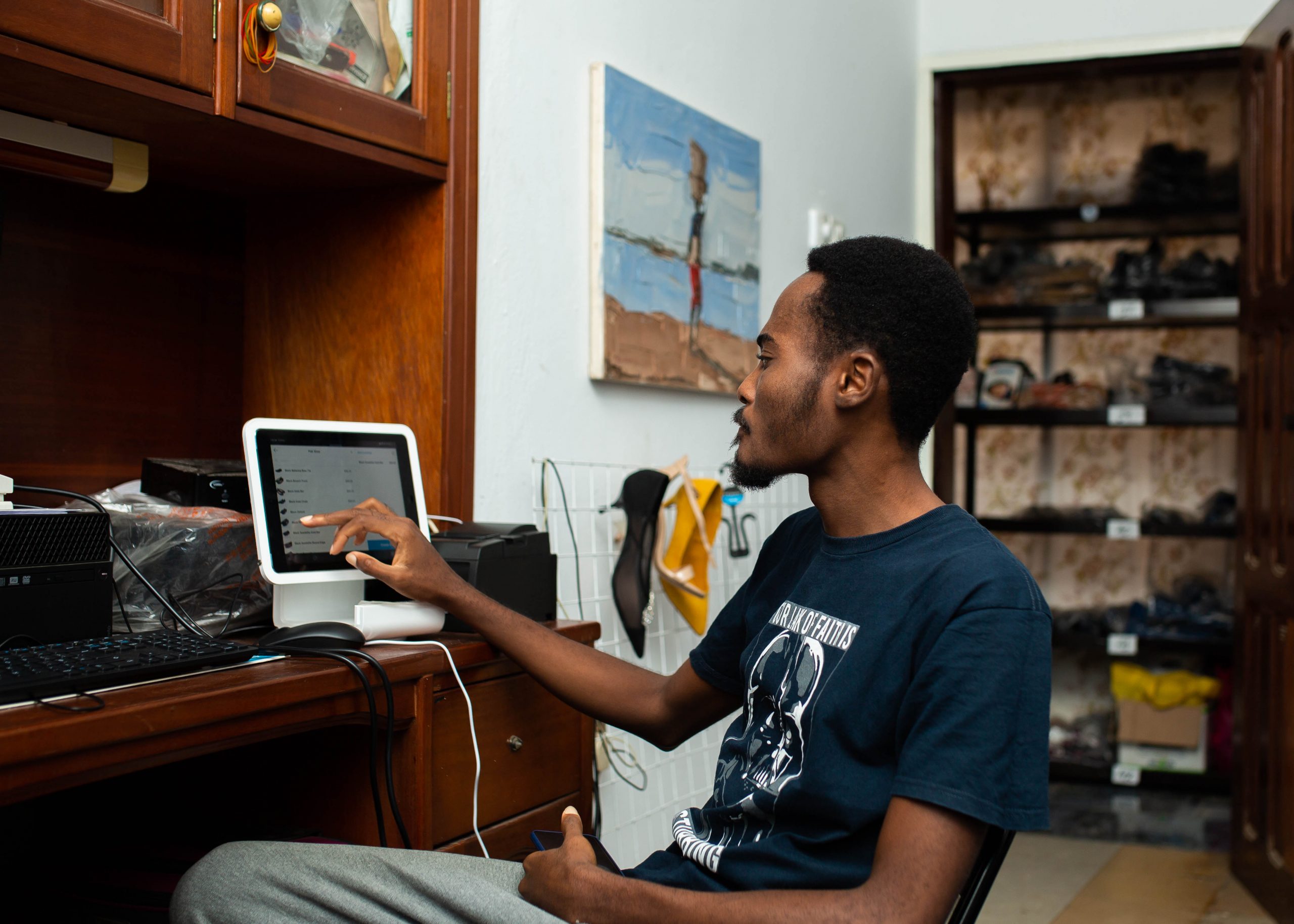 Shoemaker in Accra, Ghana, completes payment